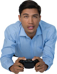 Young businessman lying down while playing video game