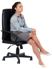 Portrait of a serious businesswoman sitting on an armchair