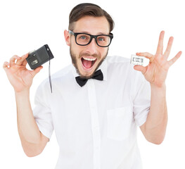 Geeky hipster holding a retro tape cassette player