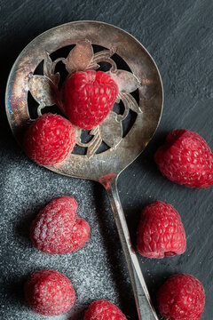 Raspberries on Blueish Background with Vintage Spoon