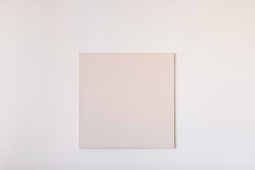 Blank square canvas on the wall. Picture, poster mockup, template. Art gallery.