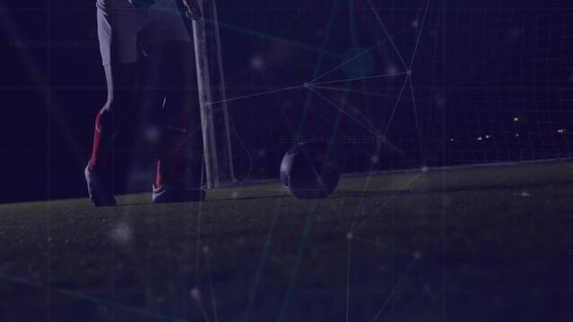 Animation of connected dots over low section of soccer player playing with football on ground