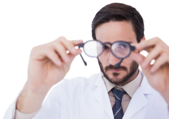 Doctor wearing lab coat looking through eyeglasses