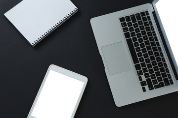 Laptop, digital tablet and organizer on black background