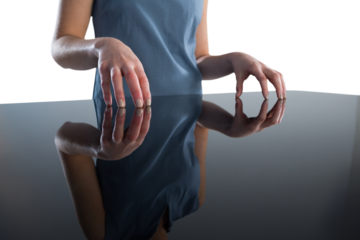 Mid section of businesswoman gesturing at table