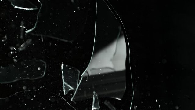 Super Slow Motion Shot of Breaking Real Glass at 1000 fps. Isolated on Black Background.
