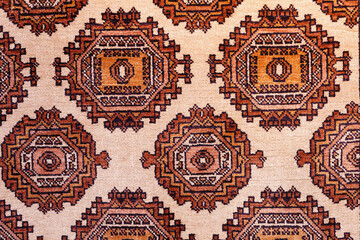 Close up of Traditonal uzbekistan pattern on a colorful handmade silk carpet  in red tones.