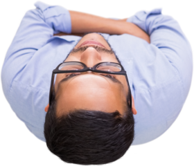 Thoughtful businessman standing against glass wall at office