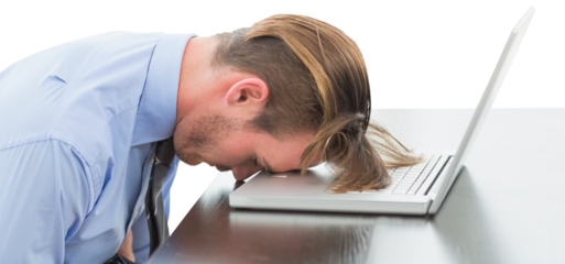 Exhausted businessman resting head on laptop
