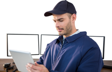 Security officer using digital tablet at desk
