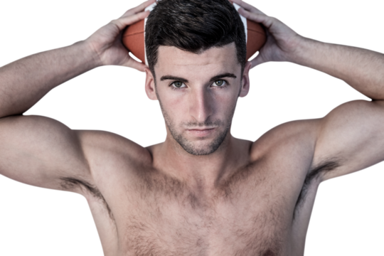 Portrait of a man holding ball over his head