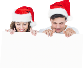 Couple with santa hat holding poster
