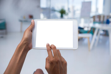 Cropped hands of female executive using tablet computer