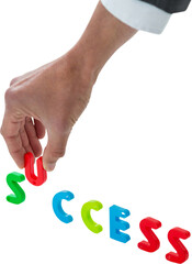Cropped hand of businessman arranging success word