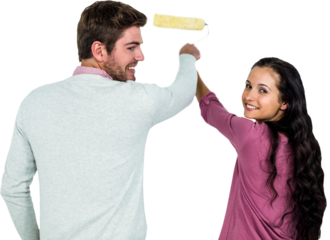 Smiling couple holding paint roller