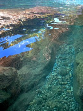 Sea underwater stones pebbles at the bottom.