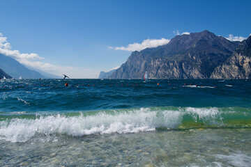Fototapeta na wymiar Lake Garda on a windy sunny day with. surfer