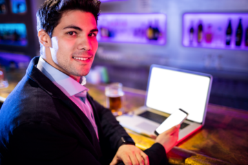Portarit of businessman holding mobile phone