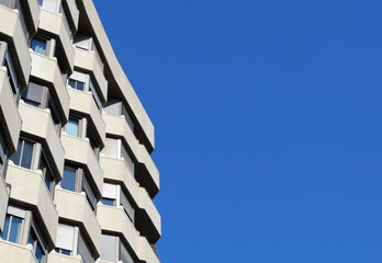 Minimal corner of modernist beige building against clear sky in the city center of Zaragoza, Aragon, Spain. Horizontal photo with backdrop
