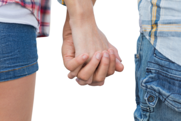 Couple in check shirts and denim holding hands