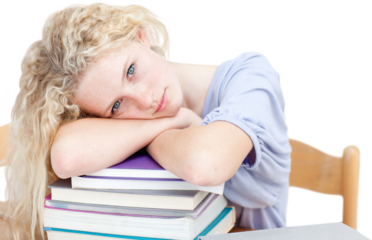 Tired teeenager sleeping in a library