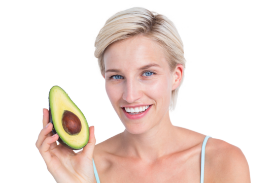 Pretty blonde holding half of an avocado