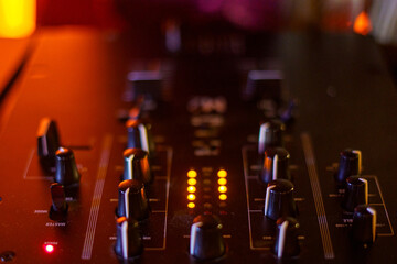 audio mixing console with knobs and faders