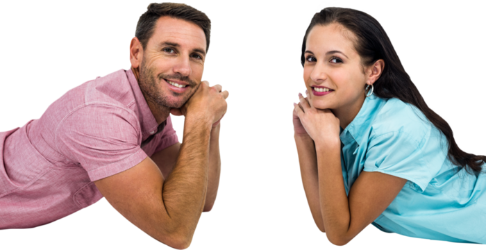 Smiling couple laying on the floor face to face looking at the camera