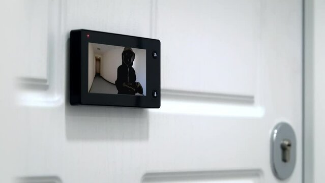 Door phone access control technology. woman turn on camera on video doorbell.