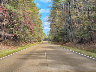 Natchez Trace Parkway a National Park Service scenic road and  old route from Natchez, Mississippi to Cumberland River in Tennessee. No traffic on a road lined with autumn trees and fall foliage.  © EWY Media