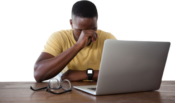 Upset man with laptop at table