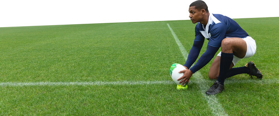Male rugby player placing the ball