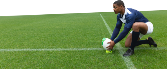 Male rugby player placing the ball