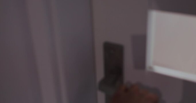 Defocused open door to boy child room unnoticed and see kid play toys. Surprised child looks at father that silently entered room.