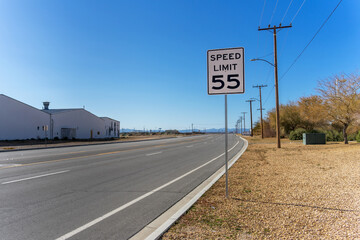 A 55 Speed Limit street sign on a empty - obrazy, fototapety, plakaty