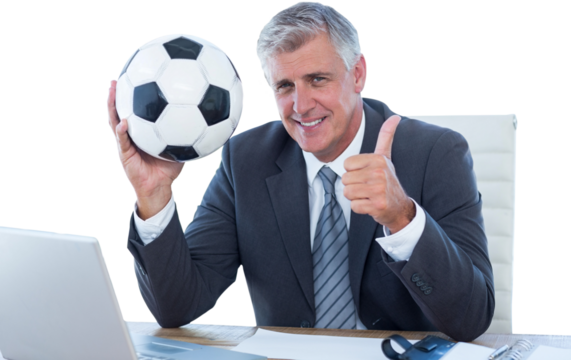 Smiling businessman holding soccer ball with thumbs up