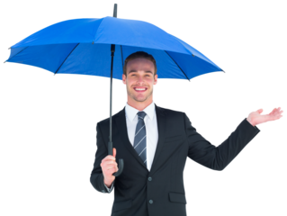 Businessman sheltering under black umbrella