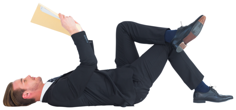 Relaxed businessman lying and reading document