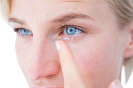 Pretty blonde applying contact lens