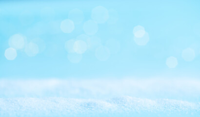 Snow on a blue background with light. Winter banner.