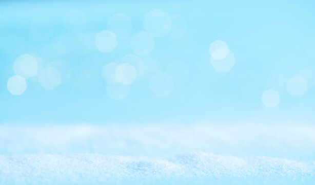 Snow on a blue background with light. Winter banner.