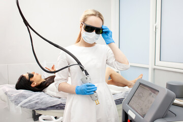 doctor cosmetologist in uniform holds alexandrite laser, professional hair removal in cosmetology...