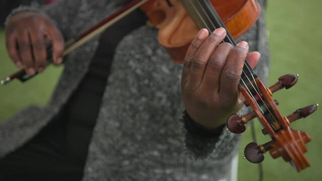 Close up of Playing the violin. Musician play music. Classical music playing stringed classical musical instruments talented people in art. Woman playing outdoors. High quality 4k