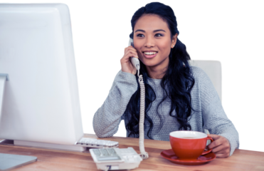 Smiling Asian woman on phone call holding mug