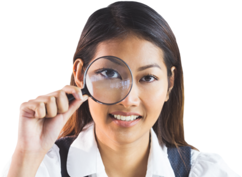 Businesswoman looking through magnifying glass