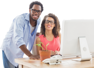 Portrait of creative business people using computer at desk