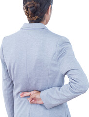 Businesswoman with fingers crossed behind her back over white background