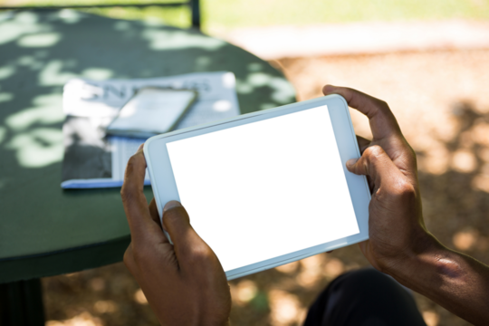 Man using digital tablet at outdoor restaurant