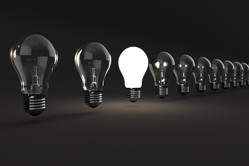 Electric light bulbs over black background