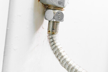 water is flowing from a broken shower hose. 